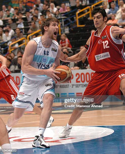 Andres Nocioni of Argentina drives in the paint as Turkey forward Kerem Gonlum tries to prevent him during the FIBA World Championship 2006...