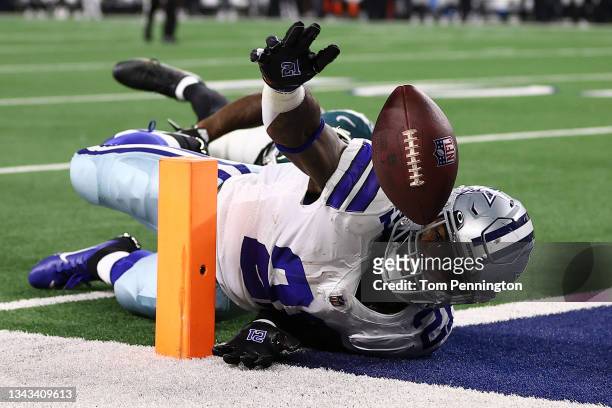 Ezekiel Elliott of the Dallas Cowboys loses the ball trying to reach for the end zone during a first half run in front of Darius Slay of the...