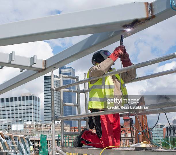 welder working on construction site - welding stock pictures, royalty-free photos & images
