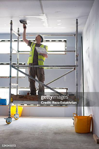 plasterer in new construction - plastering stock pictures, royalty-free photos & images