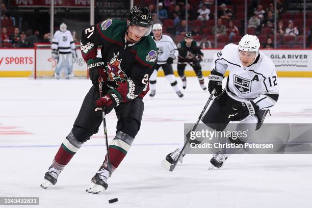 Loui Eriksson of the Arizona Coyotes skates with the puck ahead of Trevor Moore of the Los Angeles Kings during the first period of the preseason NHL...