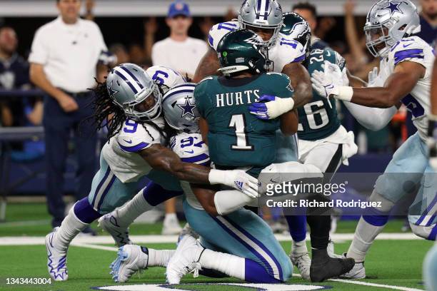 Jalen Hurts of the Philadelphia Eagles is sacked buy the Dallas Cowboys defense in the second half at AT&T Stadium on September 27, 2021 in...