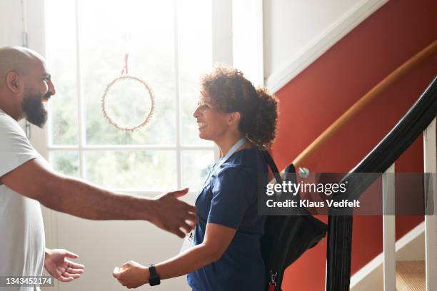 happy female healthcare worker greeting man - introducing boyfriend stock pictures, royalty-free photos & images