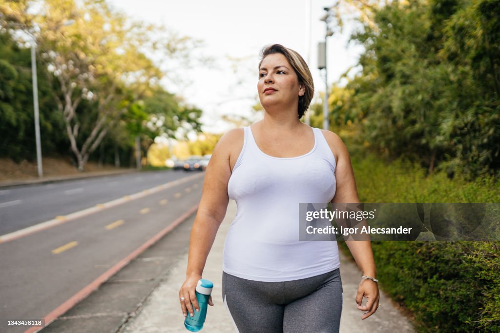 Woman walking in the city park