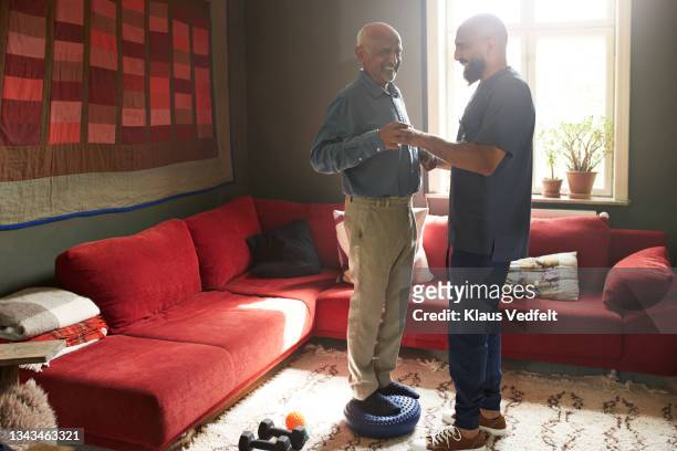 man taking support of male caregiver - needs improvement stock pictures, royalty-free photos & images