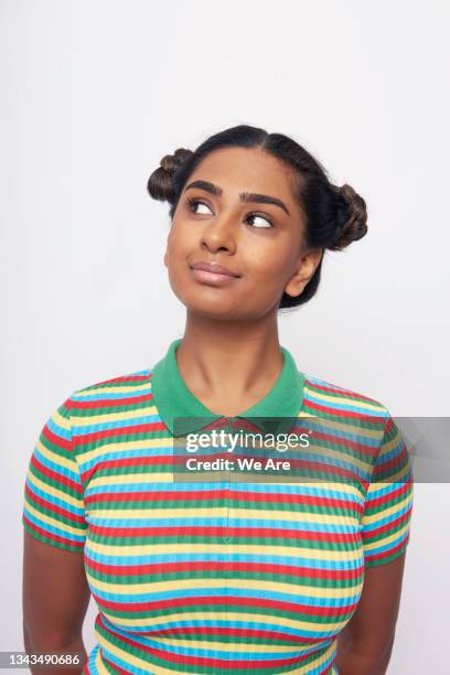 young woman in striped top, smiling and looking the side - offbeat stock pictures, royalty-free photos & images