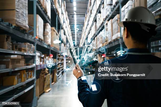 man with tablet hand holding in factory storehouse - aircraft wifi stock pictures, royalty-free photos & images