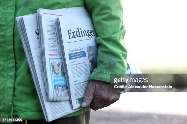Johann Böhm looks on as he delivers local newspapers to residents on the day after German federal parliamentary elections on September 27, 2021 in...