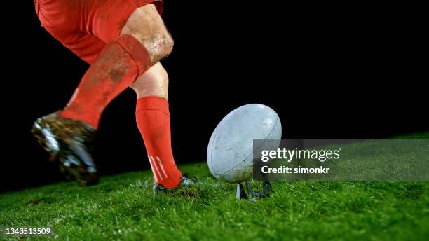 rugby player kicking ball - rugby ball stock pictures, royalty-free photos & images