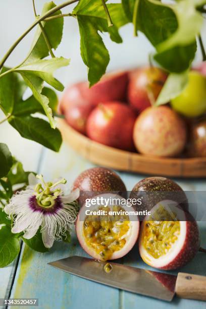 sliced cross-section of a freshly picked passion fruit. - passion fruit flower images stock pictures, royalty-free photos & images