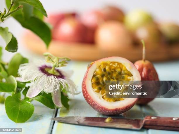 sliced cross-section of a freshly picked passion fruit. - passion fruit flower images stock pictures, royalty-free photos & images