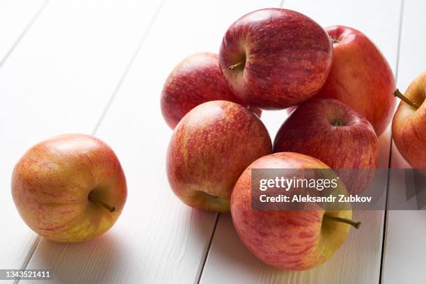 red apples, on a white wooden background. vegetables and fruits on the kitchen dining table. cultivation of organic farm ecological products. the concept of vegetarian, vegan, raw food food and diet. copy the space. - red apples stock pictures, royalty-free photos & images