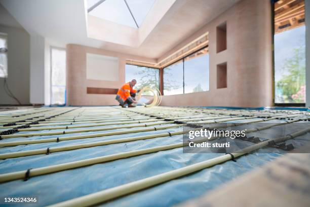 plumber installing underfloor heating - temperature bildbanksfoton och bilder