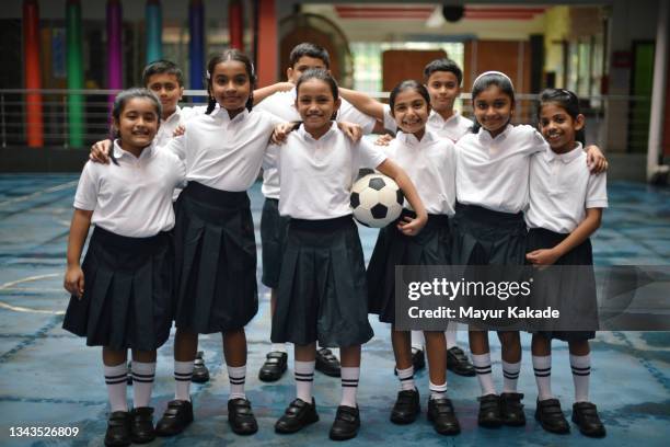 soccer team photograph of school children in school courtyard - indian football stock pictures, royalty-free photos & images