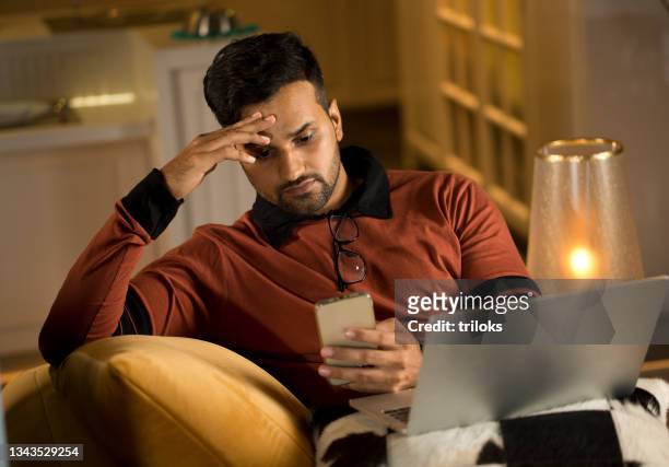 man feeling depressed on receiving bad news using phone - upset man stock pictures, royalty-free photos & images