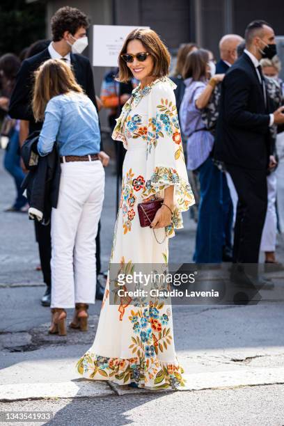 Guest, wearing a long printed dress, poses ahead of the Etro fashion show during the Milan Fashion Week - Spring / Summer 2022 on September 23, 2021...