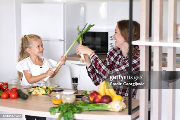 a mother and daughter in the kitchen - leek stock pictures, royalty-free photos & images