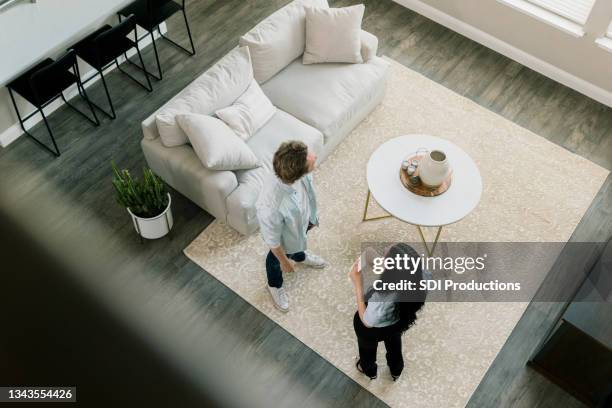 high angle view real estate agent showing home to man - ethnic millennial real estate stockfoto's en -beelden