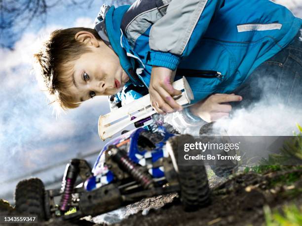 boy playing with remote controlled car - remote controlled car fotografías e imágenes de stock