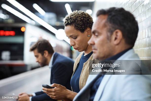 business people waiting at subway station - waiting for train stock pictures, royalty-free photos & images