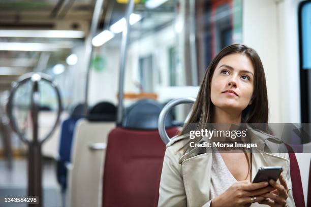 contemplated businesswoman in subway train - femme métro photos et images de collection