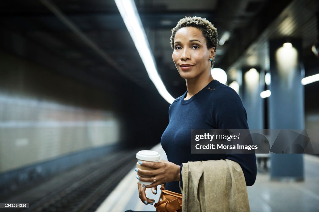 Businesswoman waiting for train at subway station