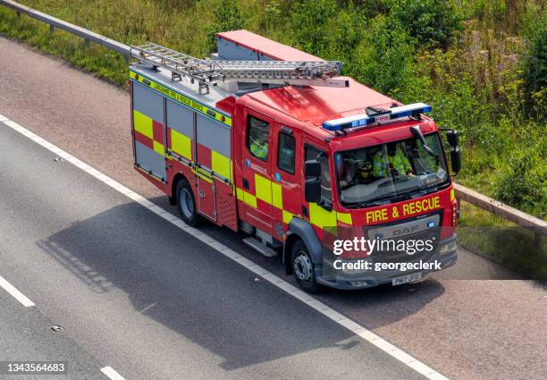 fire engine on a motorway hard shoulder - fire rescue stock pictures, royalty-free photos & images