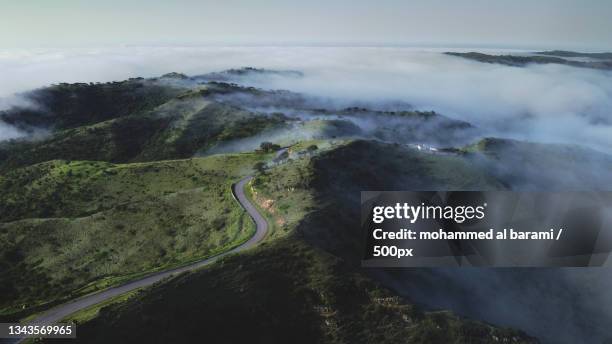 scenic view of mountains against sky,salalah,oman - salalah stock pictures, royalty-free photos & images