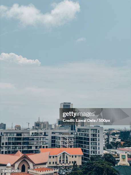 high angle view of buildings in city against sky,lagos,nigeria - lagos skyline stockfoto's en -beelden