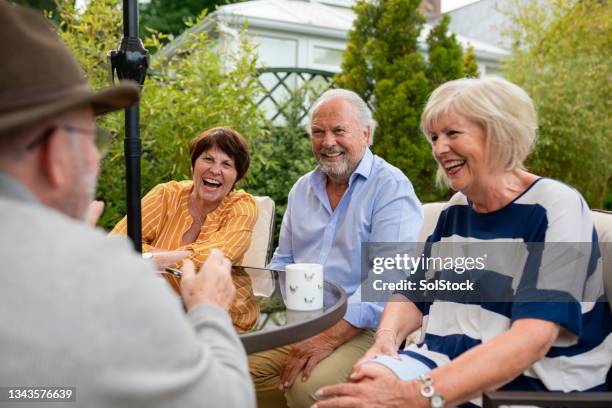 friends having a laugh in the garden - senior adult friends stock pictures, royalty-free photos & images