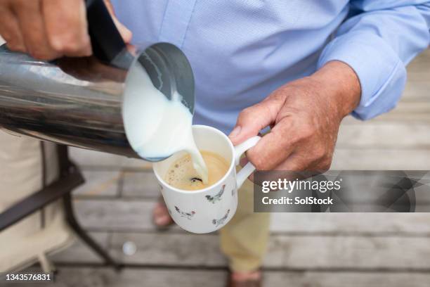 unrecognisable senior man making a coffee - coffee milk stockfoto's en -beelden