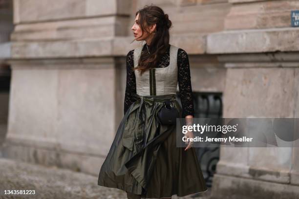 Masha Sedgwick wearing a green dirndl, a black bag on September 23, 2021 in Berlin, Germany.