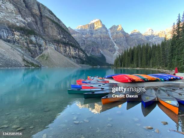 moraine lake canoes at dawn - banff national park stock pictures, royalty-free photos & images