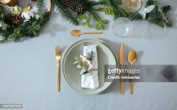 new year's eve preparations: top view of elegant christmas table setting - christmas plate stock pictures, royalty-free photos & images