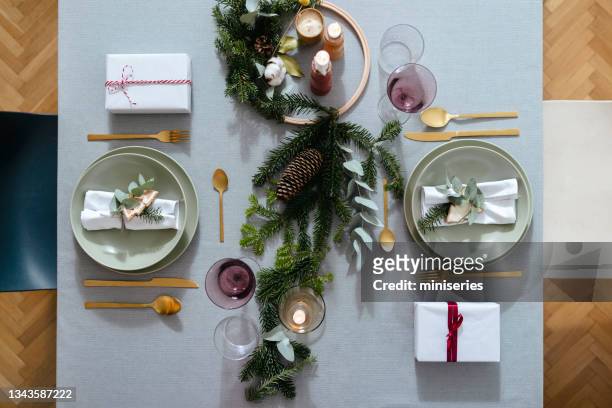 new year's eve preparations: top view of elegant christmas table setting for two people - hostesses stockfoto's en -beelden
