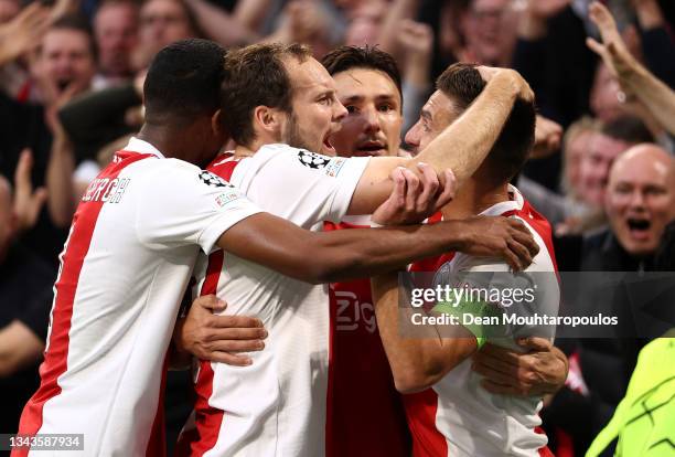 Steven Berghuis of Ajax celebrates with team mate Daley Blind after scoring their sides first goal during the UEFA Champions League group C match...