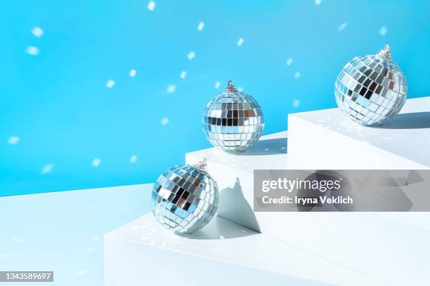 silver disco balls on white steps and pastel blue  color background.  merry christmas, happy new year invitation. - silver disco ball stock pictures, royalty-free photos & images