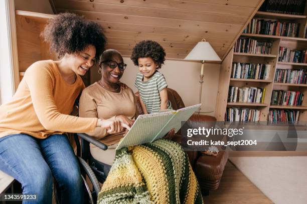family reading - multi generation family black stock pictures, royalty-free photos & images