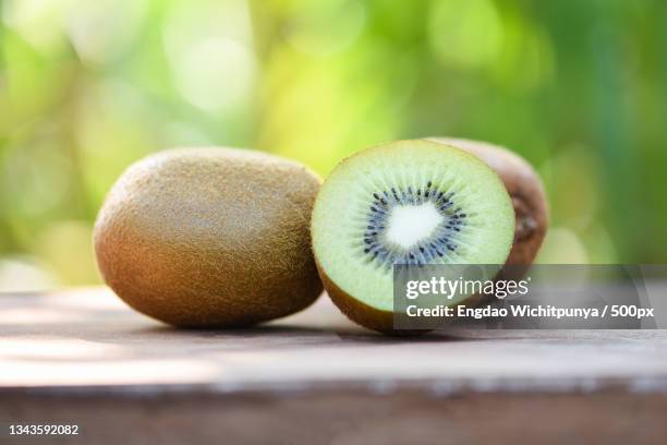 close-up of kiwi on table - kiwi foto e immagini stock
