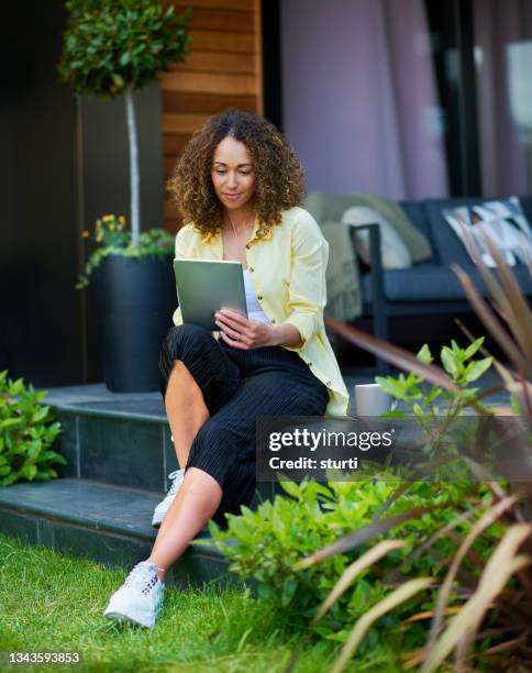 tablet on the patio - garden ipad stock pictures, royalty-free photos & images