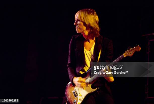 American Rock and Pop musician Tom Petty plays guitar as he leads his band, the Heartbreakers, during a performance on the 'Damn the Torpedoes' tour...