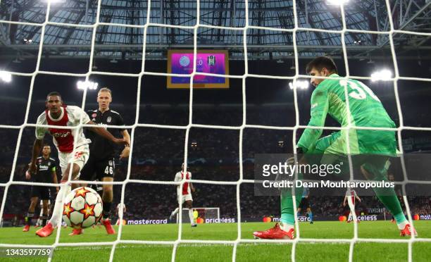 Sebastien Haller of Ajax scores their side's second goal past Ersin Destanoglu of Besiktas during the UEFA Champions League group C match between AFC...