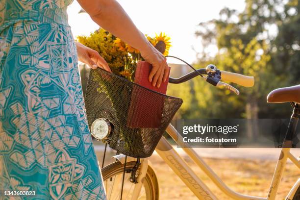 packing a book in a bike basket after reading and reading - bicycle basket stock pictures, royalty-free photos & images