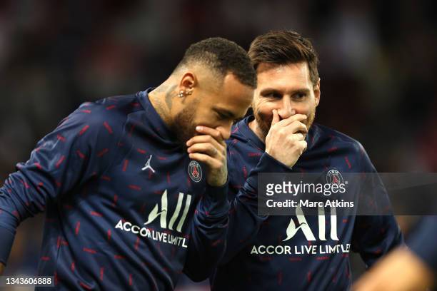 Neymar and Lionel Messi of Paris Saint-Germain speak during the warm up prior to the UEFA Champions League group A match between Paris Saint-Germain...