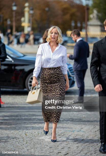 Lucie de la Falaise is seen wearing skirt with leopard print, white button shirt outside Dior on September 28, 2021 in Paris, France.