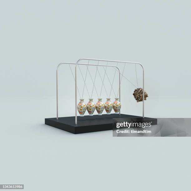 newton's cradle made of porcelain vases almost hit by a rock - consumer spending power weakens bildbanksfoton och bilder