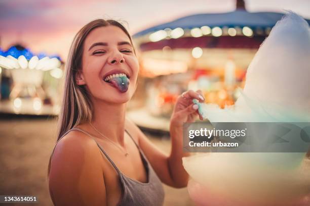 woman showing painted tongue from eating cotton candy - candy on tongue stock pictures, royalty-free photos & images