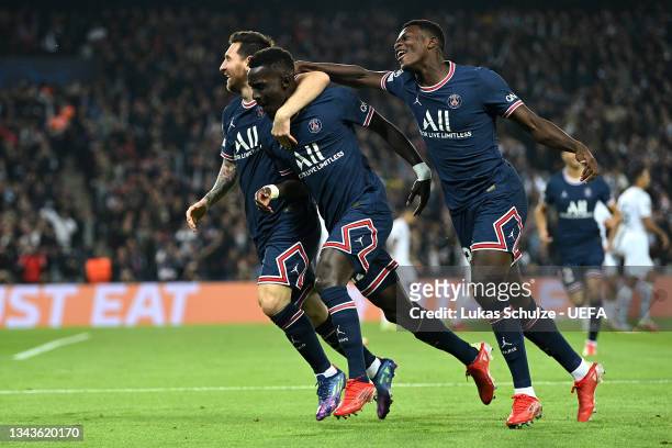 Idrissa Gueye of Paris Saint-Germain celebrates with team mates Lionel Messi and Nuno Mendes after scoring their sides first goal during the UEFA...