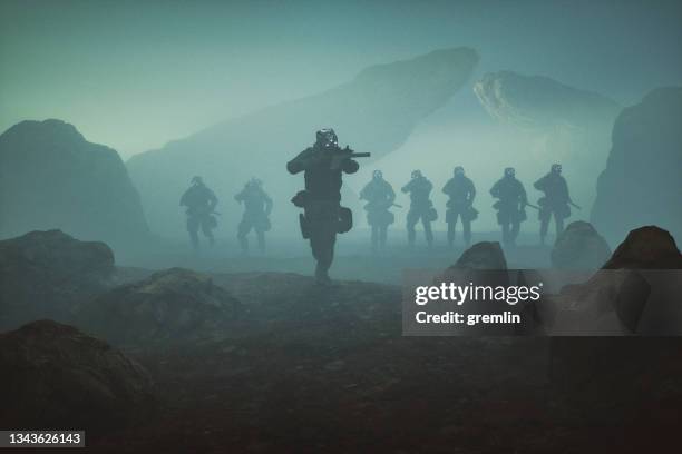 futuristic soldiers walking over rocky terrain - special forces stockfoto's en -beelden