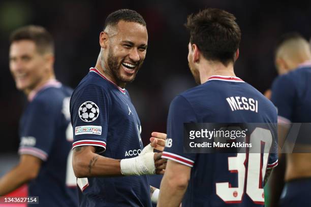 Lionel Messi of Paris Saint-Germain celebrates with teammate Neymar after scoring his team's second goal during the UEFA Champions League group A...